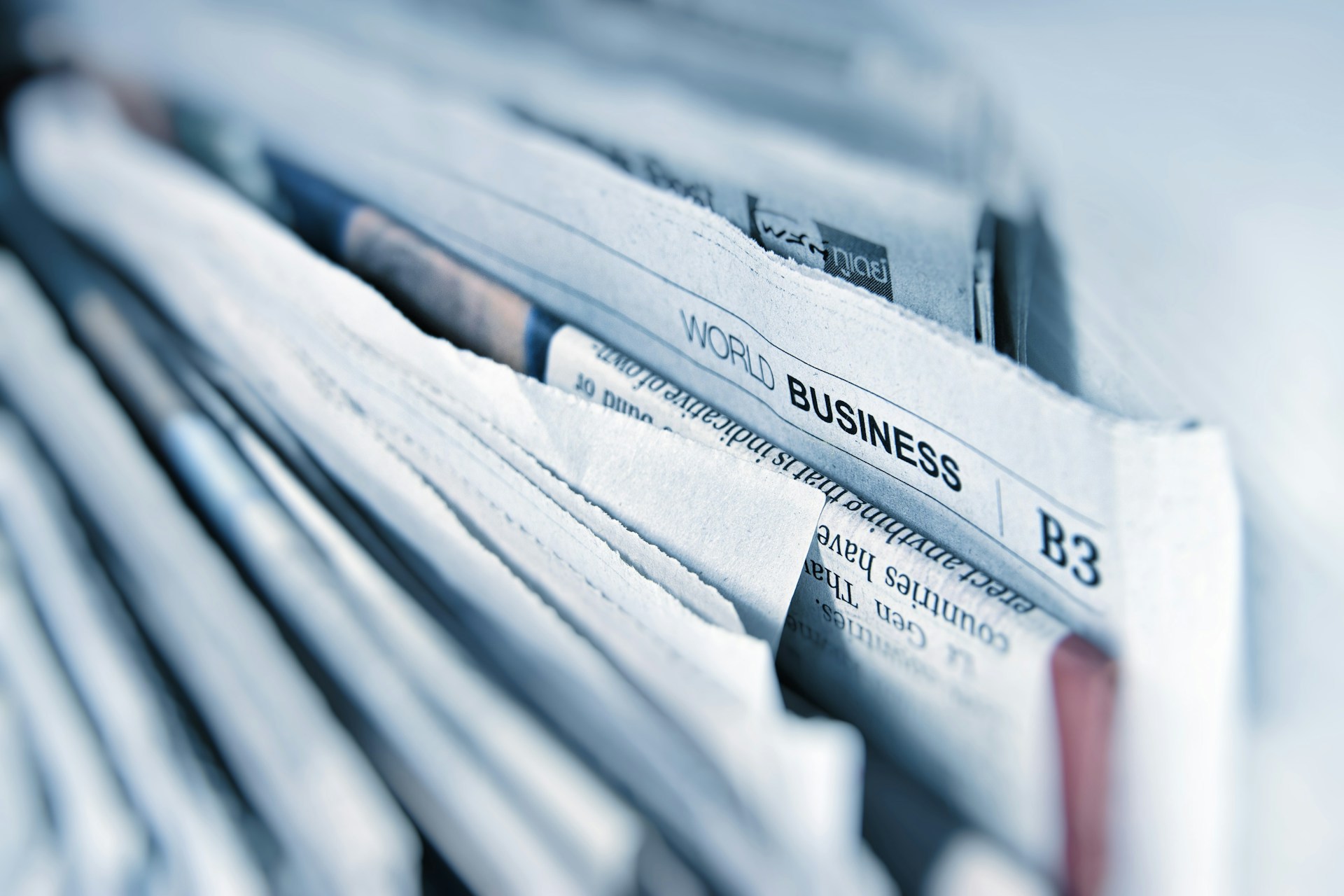Stack of paper proofs and editorial documents on a black surface